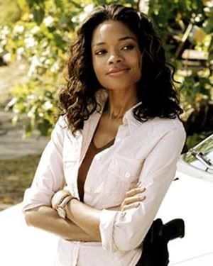 Naomie Harris, black actress with long black curly hair, looking awesome